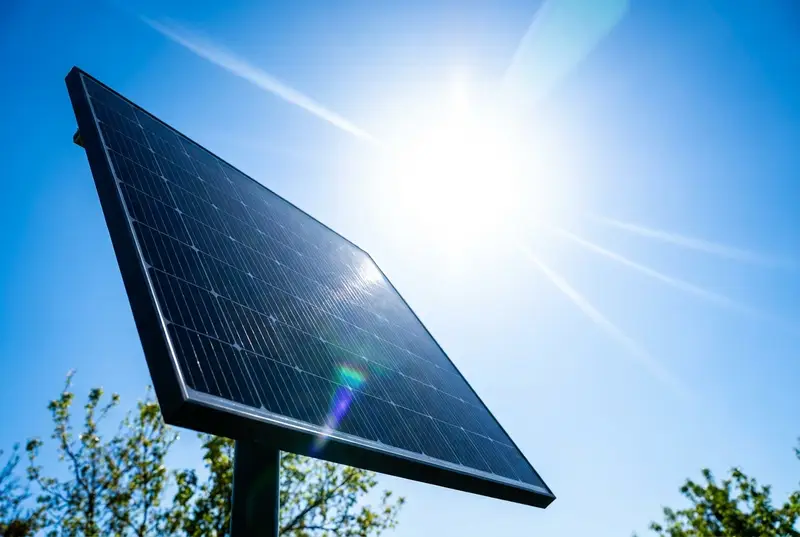 Solar panel facing bright sunshine in a clear blue sky